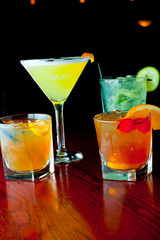 Cocktails. Traditional American drinks made by artisanal bartenders or mixologists in speakeasy & upscale bars or dives or taverns.Cocktails served in chilled cocktail glasses & garnished with fruit.