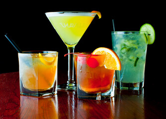 Cocktails. Traditional American drinks made by artisanal bartenders or mixologists in speakeasy & upscale bars or dives or taverns.Cocktails served in chilled cocktail glasses & garnished with fruit.