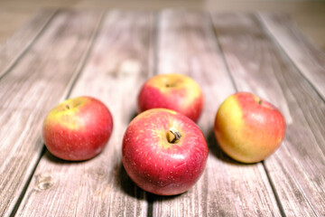 Red tasty fresh apples on a striped wooden surface
