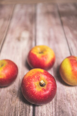 Red tasty fresh apples on a striped wooden surface
