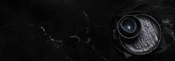 Banner of black empty plates on a black marble background. Cooking background.