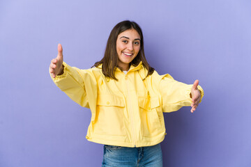 Young caucasian woman feels confident giving a hug to the camera.