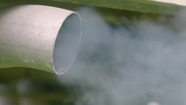 CLOSE UP large van exhaust coughs thick diesel smoke as engine starts