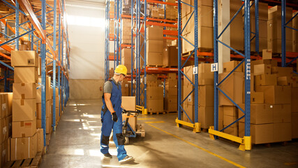 Worker Moves Cardboard Boxes using Manual Pallet Truck, Walking between Rows of Shelves with Goods in Retail Warehouse. People Work in Product Distribution Logistics Center. Side View