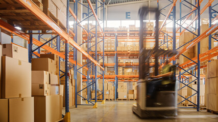 In Warehouse Shot of Blurred Forklift Driving with Pallets Moving Cardboard Boxes with Products from Shelves. Logistics Distribution Center with Products Ready for Global Shipment, Customer Delivery.