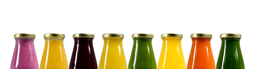 Bottles with juices of different colors. Isolated background. Healthy lifestyle. Natural vitamins. Copy space. Concept for advertising and design