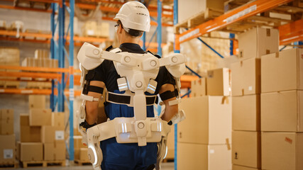 High-Tech Futuristic Warehouse: Worker Wearing Advanced Full Body Powered exoskeleton, Walks with Heavy Cardboard Box. Exosuit amplifies Human strength. Back View