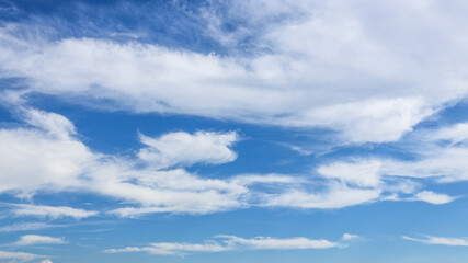 Obraz premium White clouds on blue dramatic sky Sunbeam, background look abstract nature.