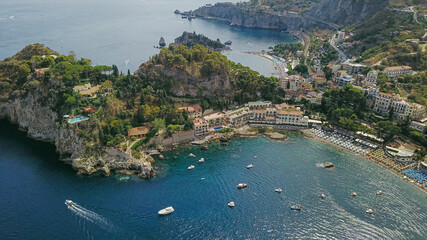 Naklejka premium View over the beaches of Taormina, Italy, with turquoise sea and a sunny sky