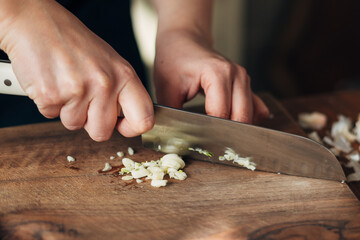 Close up shot of chef chopping garlic