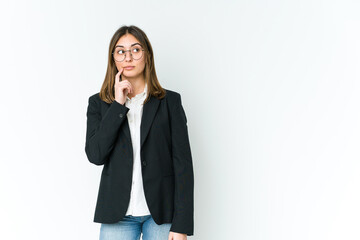 Young caucasian business woman looking sideways with doubtful and skeptical expression.