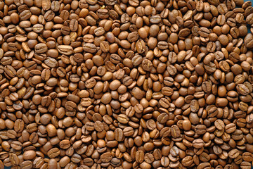 top view of fresh coffee beans on black background 