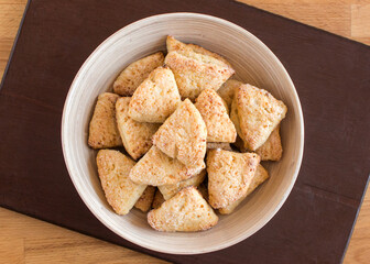 Curd ears in a plate sprinkled with sugar. Top view, no people