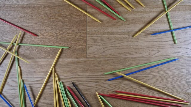 Mikado, pick-up Sticks Dropped on the Ground to Start the Game in slow motion