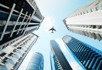 Airplane fly above buildings