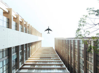 Airplane fly above buildings