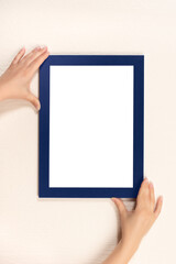 mockup diploma. woman hanging photo frame mockup on wall. White frame mockup. vertical