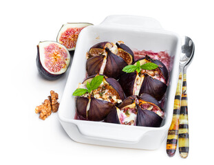 Baked figs with goat cheese and walnuts with honey isolated on white