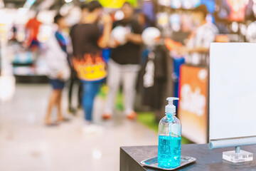Blue alcohol gel bottle for hands cleaning to prevent the spreading of the Corona virus (Covid-19),Place the entrance service for customers  in the sport store.Healthcare concept.New normal lifestyle.