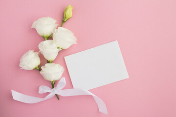 Empty white paper for text and white flowers on the pink  background