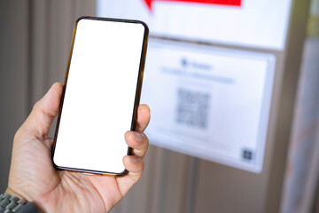 Man's hand holding smartphone scanning QR code on white isolated background, business concept