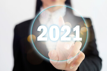 New Year 2021 concept. Business women press the button for the new beginning of 2021