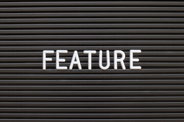 Black color felt letter board with white alphabet in word feature background