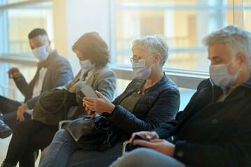 Patients sitting in waiting room with face mask, COVID-19 pandemic