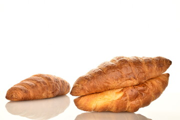 Fragrant homemade croissant, close-up, on a white background.