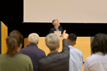 Speaker on the stage with audience in the conference hall