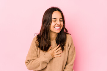 Young mixed race hispanic woman isolated laughing keeping hands on heart, concept of happiness.