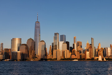 Fototapeta na wymiar Lower Manhattan Skyline along the Hudson River in New York City Shining during a Sunset