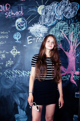 young cute teenage girl in classroom at blackboard cheerful smiling, lifestyle modern people concept