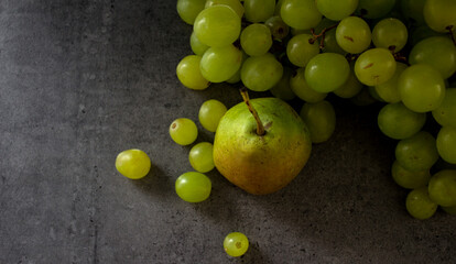 Beautiful fresh fruits on dark grey table. Fruit dieting concept. 