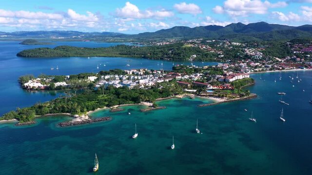 Martinique beautiful hotels marina and white sand beach at la Pointe du bout with boats in clear turquoise water 