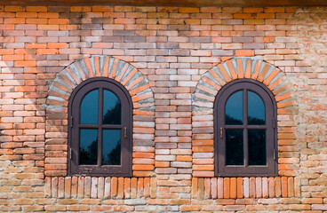 Old wooden windows with orange brick walls