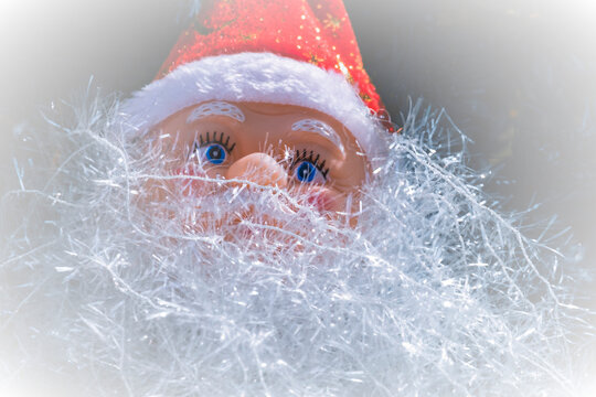 A picture of a Santa Cos figurine decorated with photo-editing techniques for use in cards or graphics.
