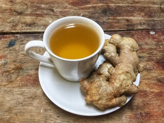 cup of ginger ale and some ginger