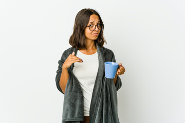 Young latin woman with blanket isolated on white background