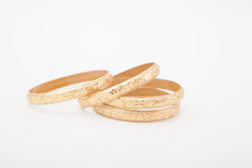 massive golden bracelets on white background