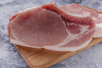 Raw fresh meat. Raw pork steak on a wooden board.