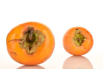 Ripe juicy organic persimmon, close-up, on a white background.