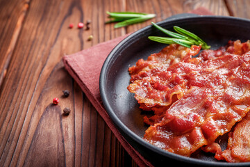 Tasty fried crispy bacon slices