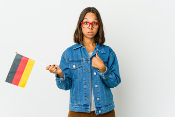 Young latin woman holding a german flag isolated on white background