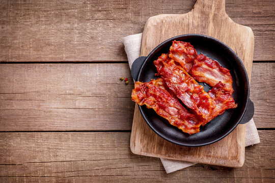 Tasty fried crispy bacon slices