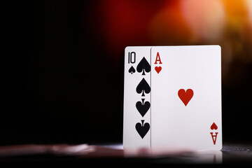 A pair of aces on a deck of playing cards against the background of a burning fireplace. Online gambling. Gambling addiction	