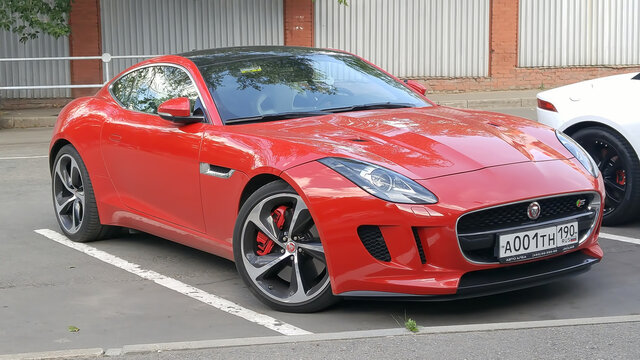 Moscow. Autumn 2018. Red Jaguar F - Type S Parked Near Porsche Dealership.