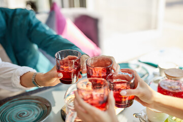 group of happy friends celebrating in cafe, they clink glasses with sweet beverages, leisure, celebration, drinks, people and holidays concept