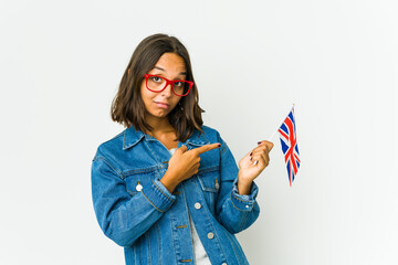 Young latin woman holding a english flag isolated on white background