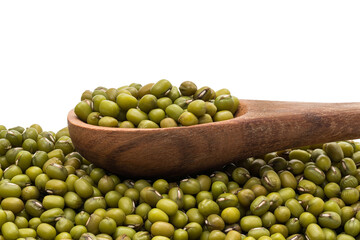 Pile of mung beans with a spoon on top seen from the side with white background 